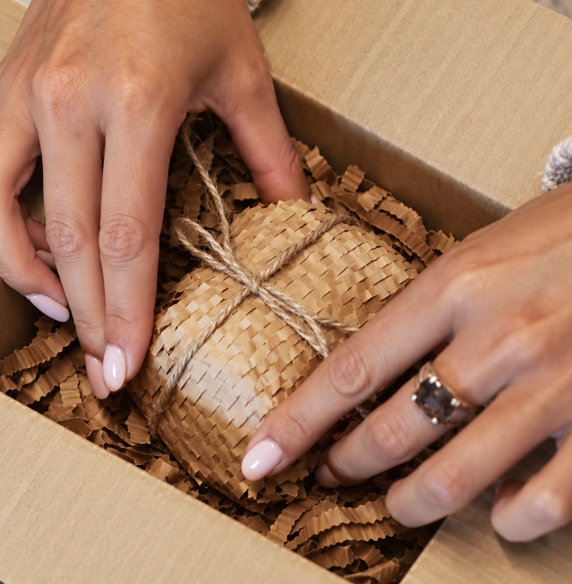 A luxury gift being wrapped in warm natural light